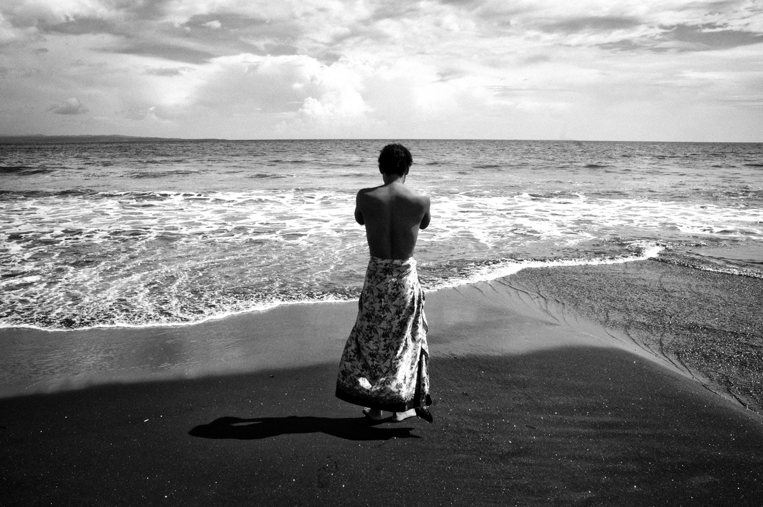 A Balinese man after washing himself at the Watuklotok Beach, Bali. Balinese believe that gods and ancestors live in the mountains whereas demons live in the sea.