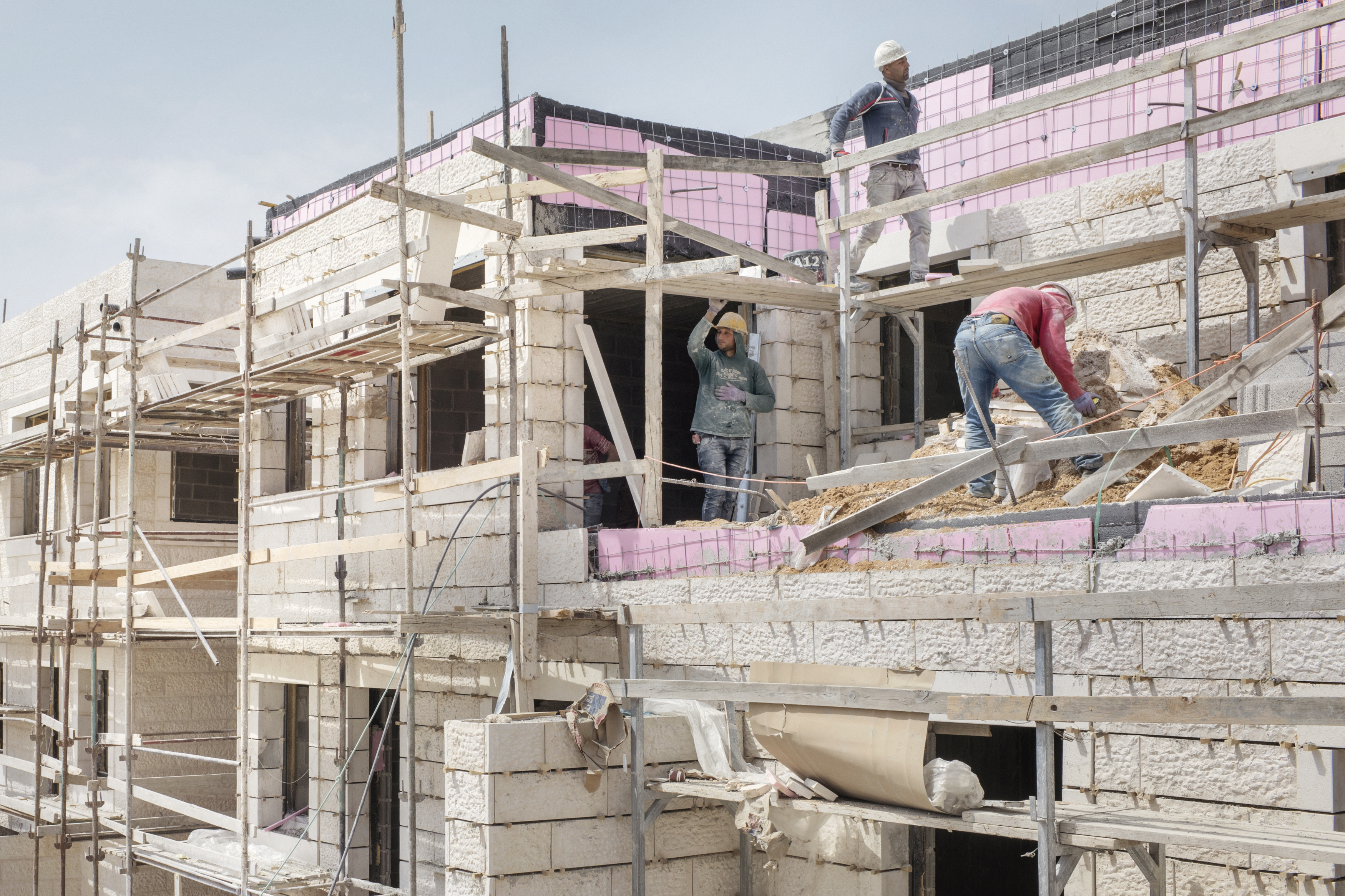 022_Israeli-settlements_MAP_7846 Gush Etzion settlement bloc, West Bank, March 2017. Palestinians at work for building new houses in the Israeli settlement of Efrat.