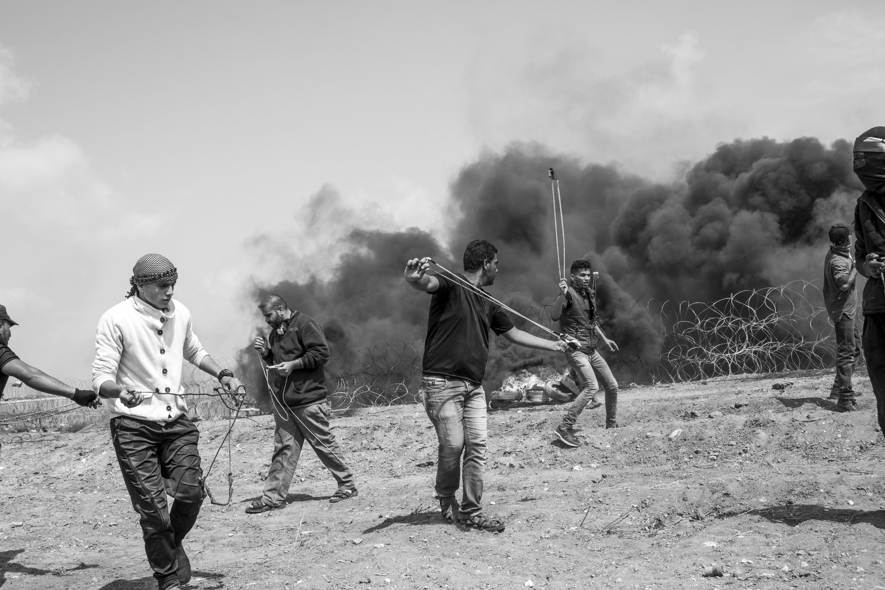 Gaza Strip, April 27, 2018. Palestinians are seen with their slinshots as they throw stones to the Israeli soldiers on the other side of the border,  in Malaka area (eastern Gaza City).