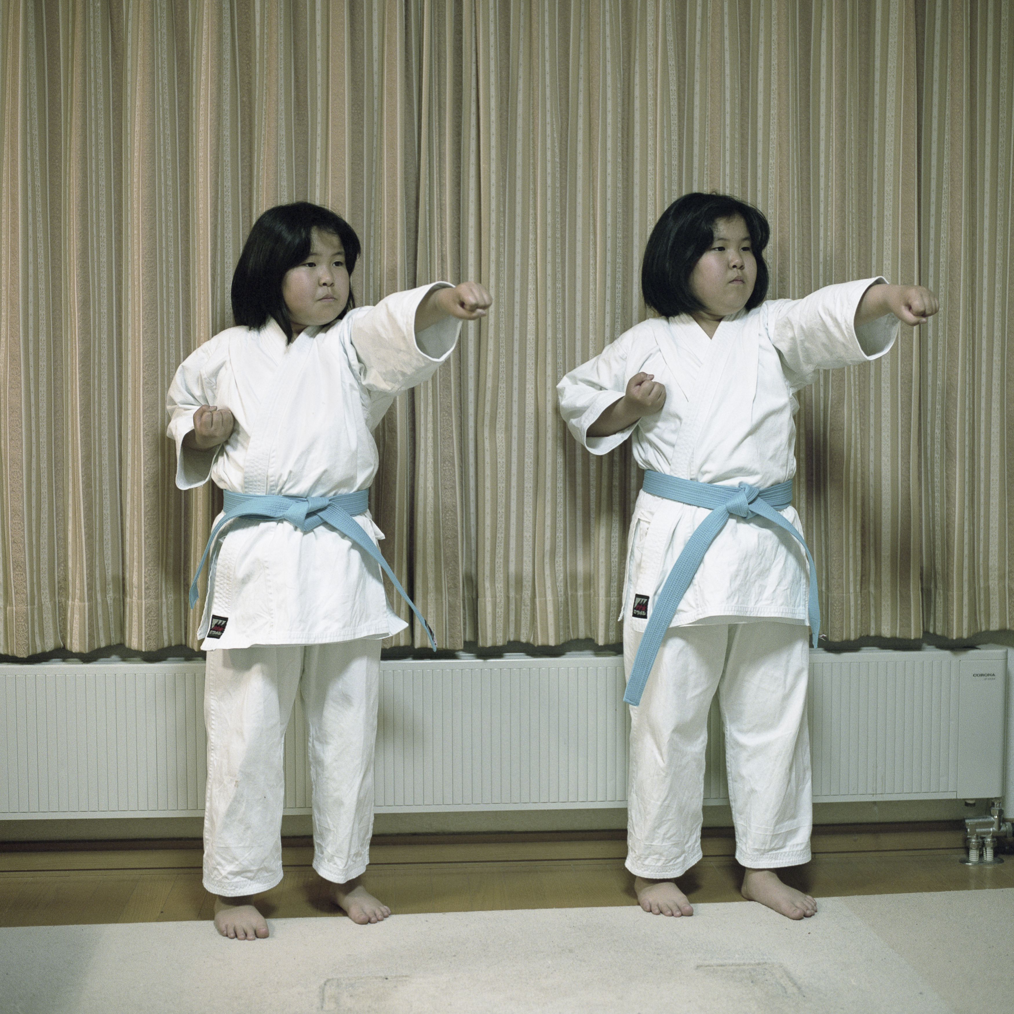 Nibutani, Hokkaido, Japan 2015 
Two Ainu sisters demonstrate karate forms in the house where they live with their parents. They study martial arts in the village cultural center where they also study Ainu language.