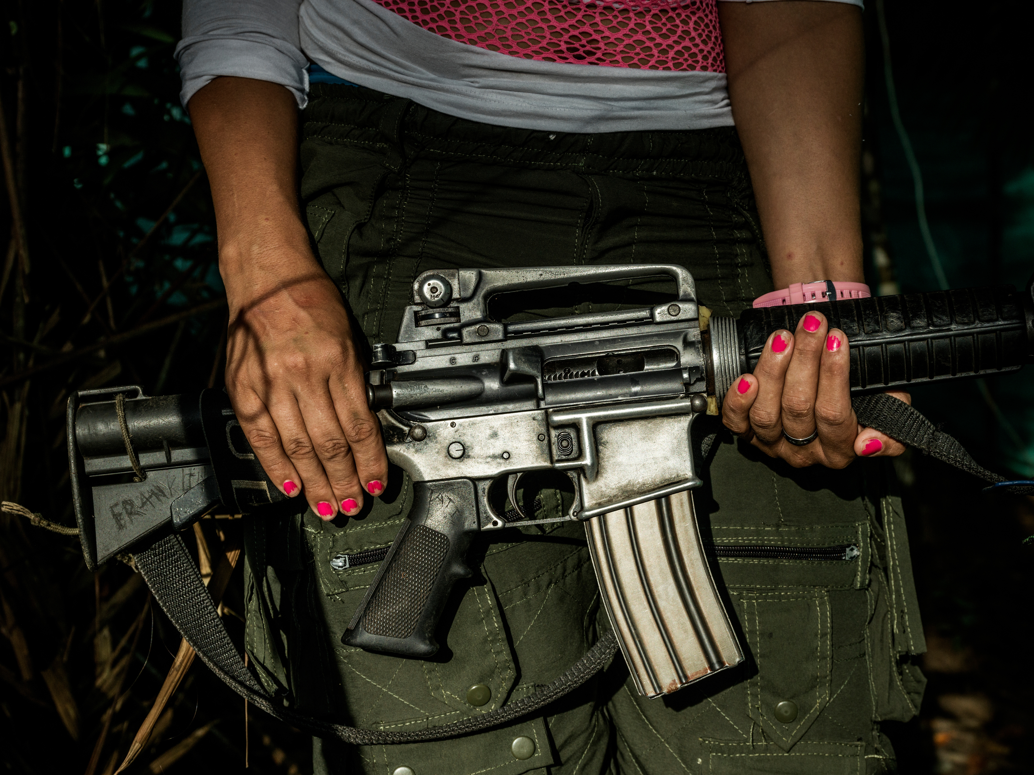 FARC guerilla Tatiaya Saens, 23, showing her AK47. She was born in the poor countryside where the guerilla had a strong presence, and joined the ranks as age 10. By joining the guerilla she eyed an opportunity for a better and more secure future, she says.