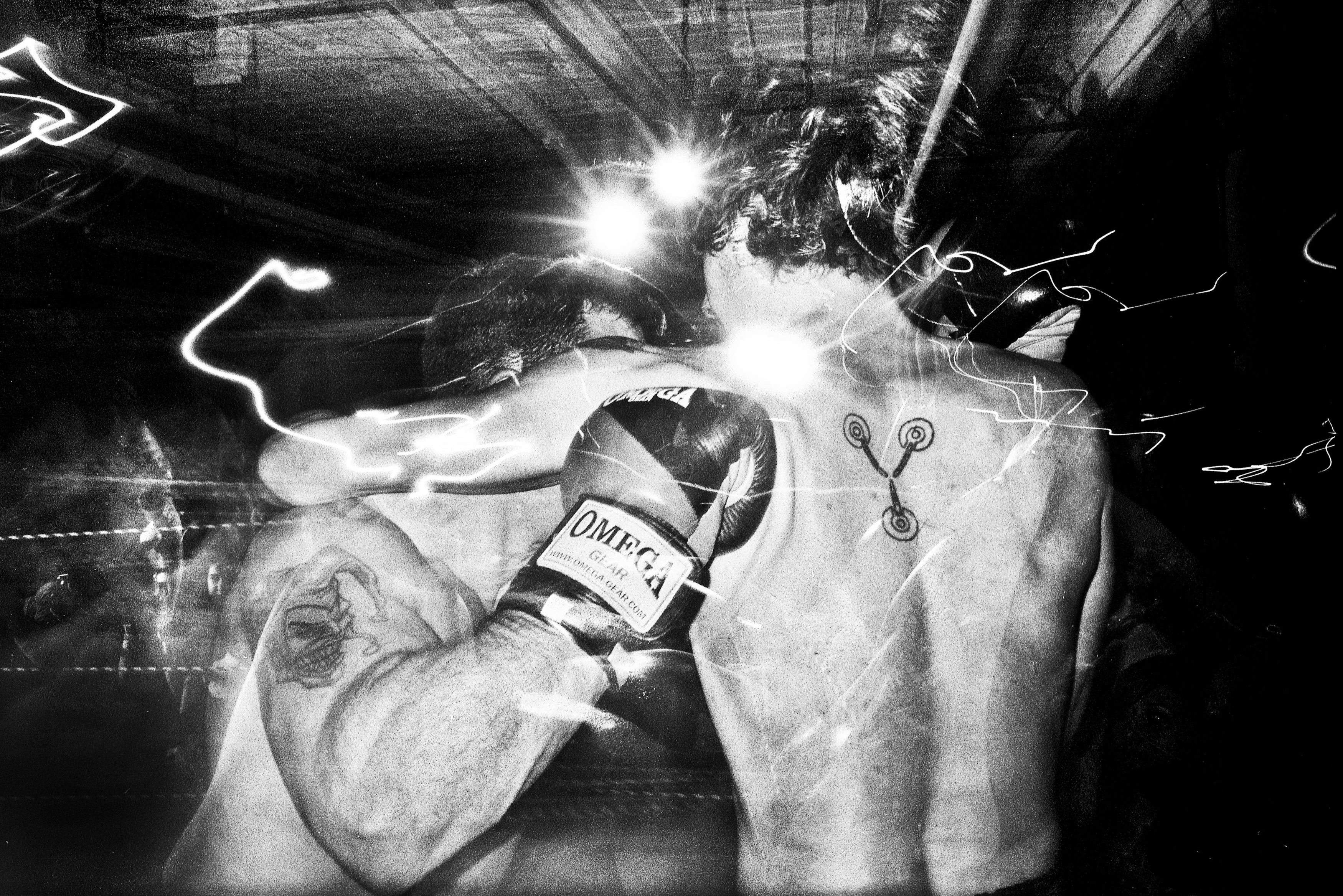 Boxers locked up in the midst of fighting, Luke Todd vs Anthony. (Lower East Side loft space, November, 2011)