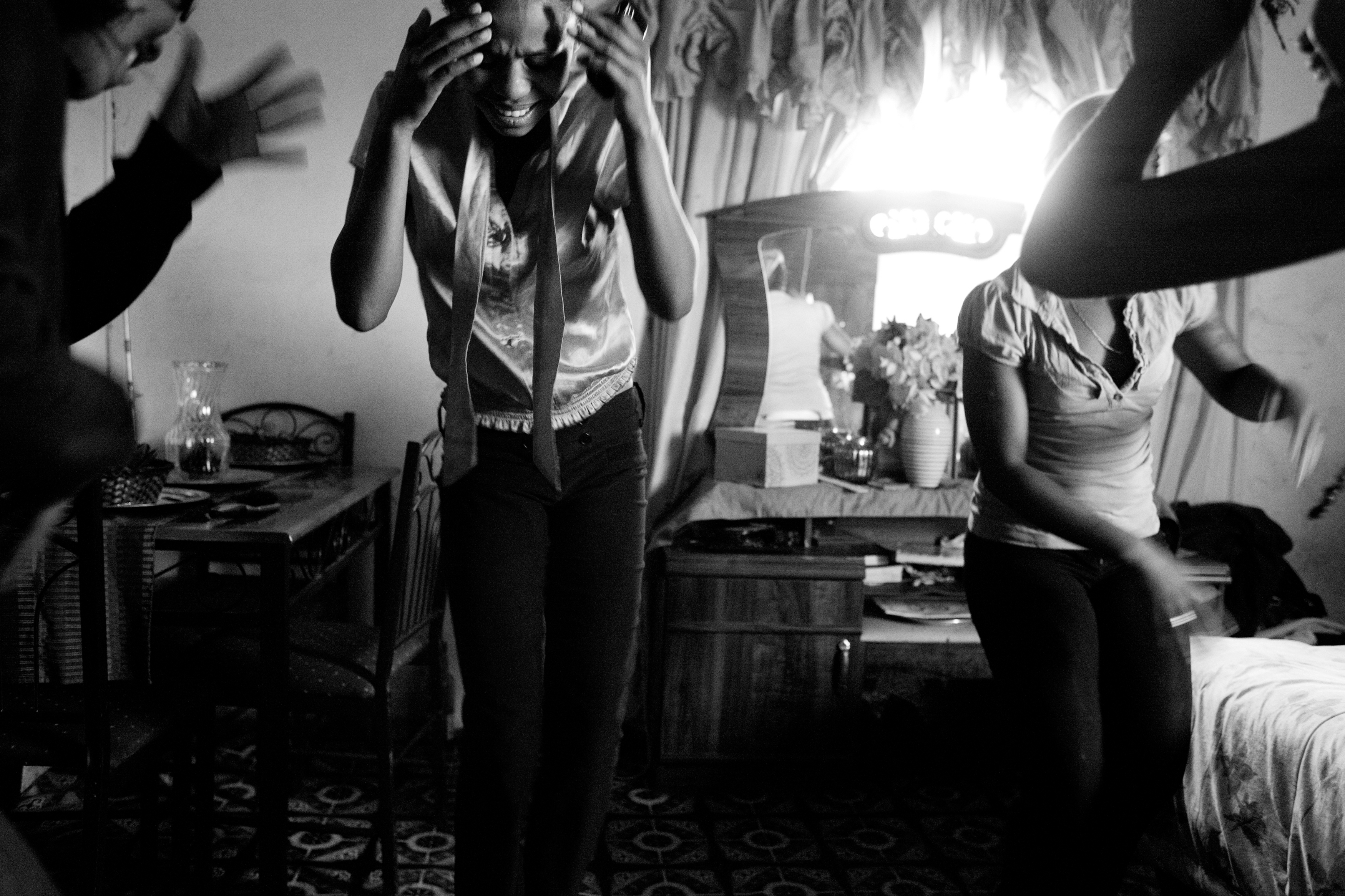 Chelmidene Whiteboy, 16 (left), and Isabelle Whiteboy, 18 (right), dance to Kwaito music with friends at their family home, in the predominately Afrikaans-speaking mixed-race neighborhood of Hooggenoeg in Grahamstown, South Africa. “I’m worried about this generation just wanting smart clothes,” says their mother, Sandra Whiteboy, “but things are changing. The young people who come in now”—to the supermarket—“know me, and they call my name. Before, with apartheid, they did not know me, and they did not call my name. I want these girls to see those changes, too.”