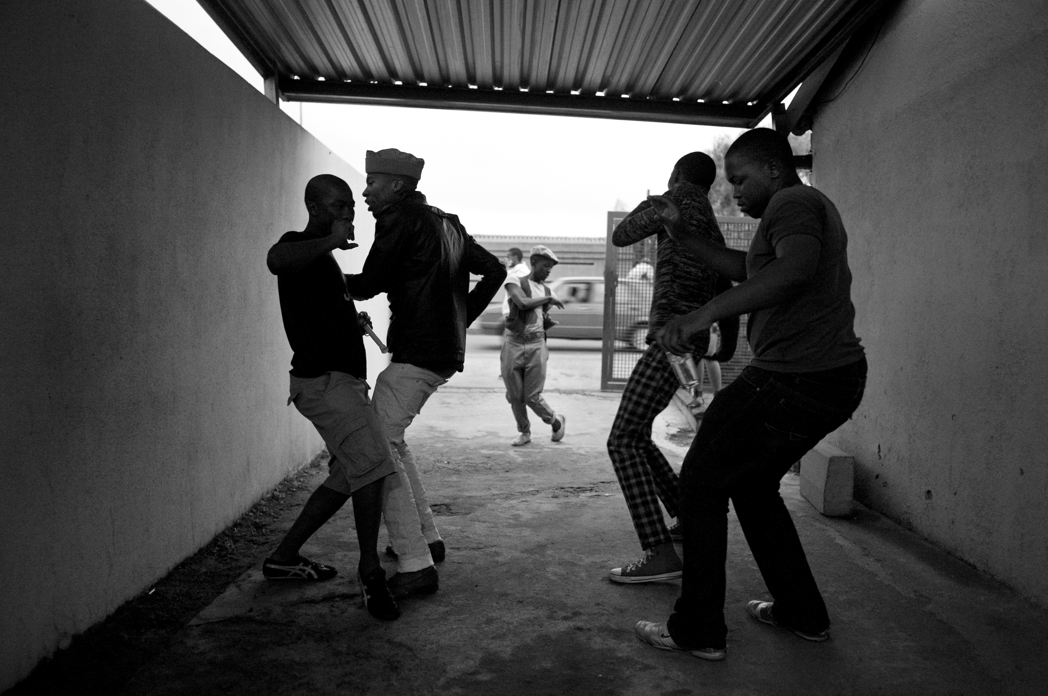 Smarteez members dance and cook dinner during a house party at Lethabo's home in Soweto.Since the days of Apartheid to its inevitable end watched closely by the world, South Africans have fought hard for collective change. This collective spirit can be seen within the community in both the politics and the arts. Since the early post-Apartheid days, Kwaito—a musical genre and culture emerging out of the South African townships—has told stories beyond just the fashion and style of dance, but also to a life impoverished and the collective spirit of the young, sexual, and free looking towards change.Today, many middle class youth will argue whether Kwaito is dead or has just evolved. But one thing is certain: the new rising middle class youth of South Africa have begun to search for expression in more individual ways. Fighting a different fight from their parents, this generation is taking the opportunity to find their sense of self. One influential group emerging from Soweto’s streets calls themselves the Smarteez, after a popular, colorful candy. These young fashionistas are quickly joining the ranks of a growing middle class youth, inspiring a new generation to break from tradition and express individuality through fashion, music, and art. All original Smarteez members are from Soweto and either met growing up in the same Apartheid-styled neighborhoods or attending integrated suburban schools their parents viewed as gateways to new and better opportunities. As classmates at the University of Johannesburg’s fashion school, they bonded over a shared experience of being raised in these two distinct worlds. By sharing designs and crashing elite fashion parties, they created a milieu of risk-taking that evolved into a movement whose liberating ideas resonated with youth around the country.While South Africa still has the second highest murder rate in the world, one of the worst HIV/AIDS epidemics, and a high unemployment rate, it also has an expanding and