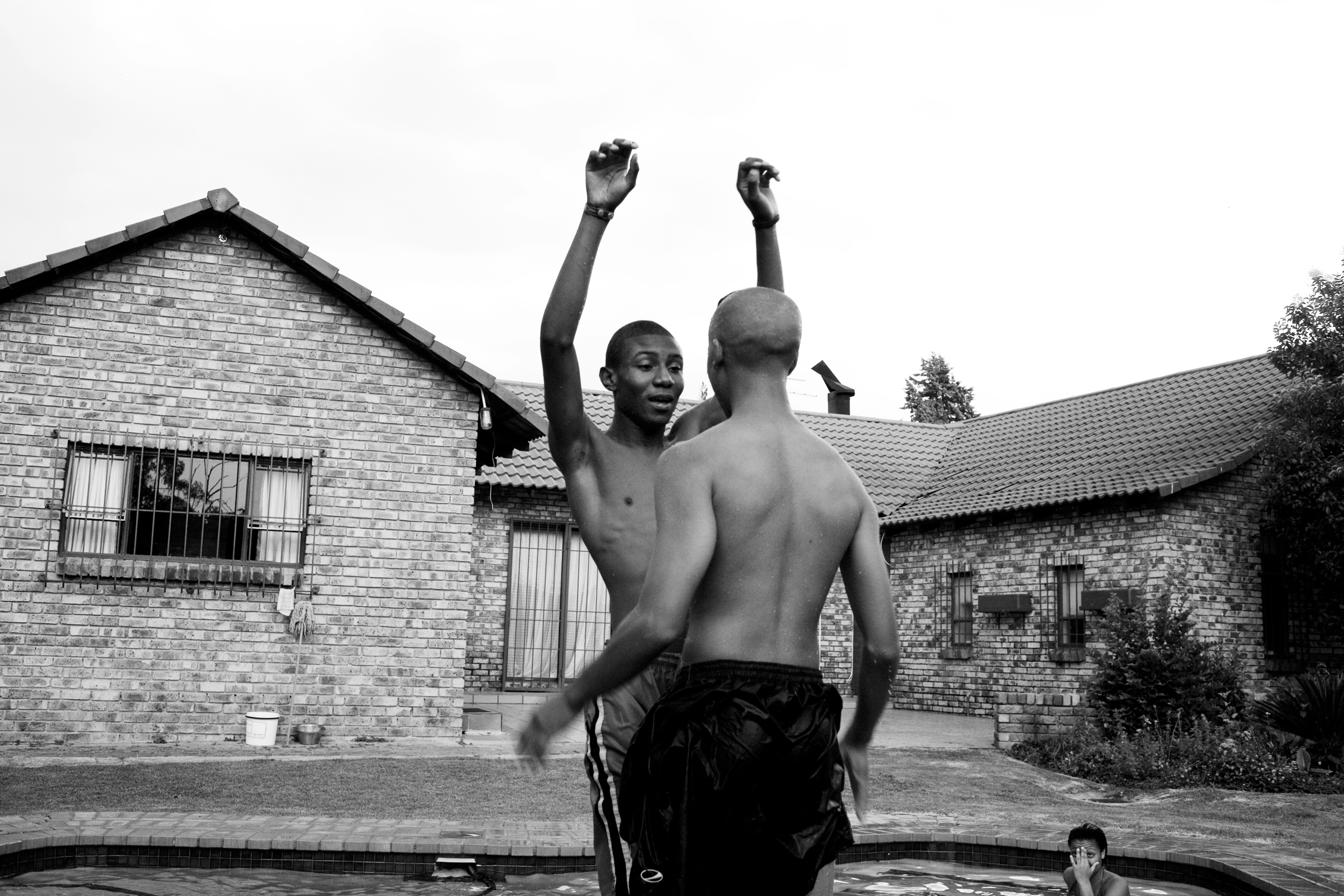 Friends play around the pool in the growing middle class neighborhood of Kibler Park, Johannesburg.