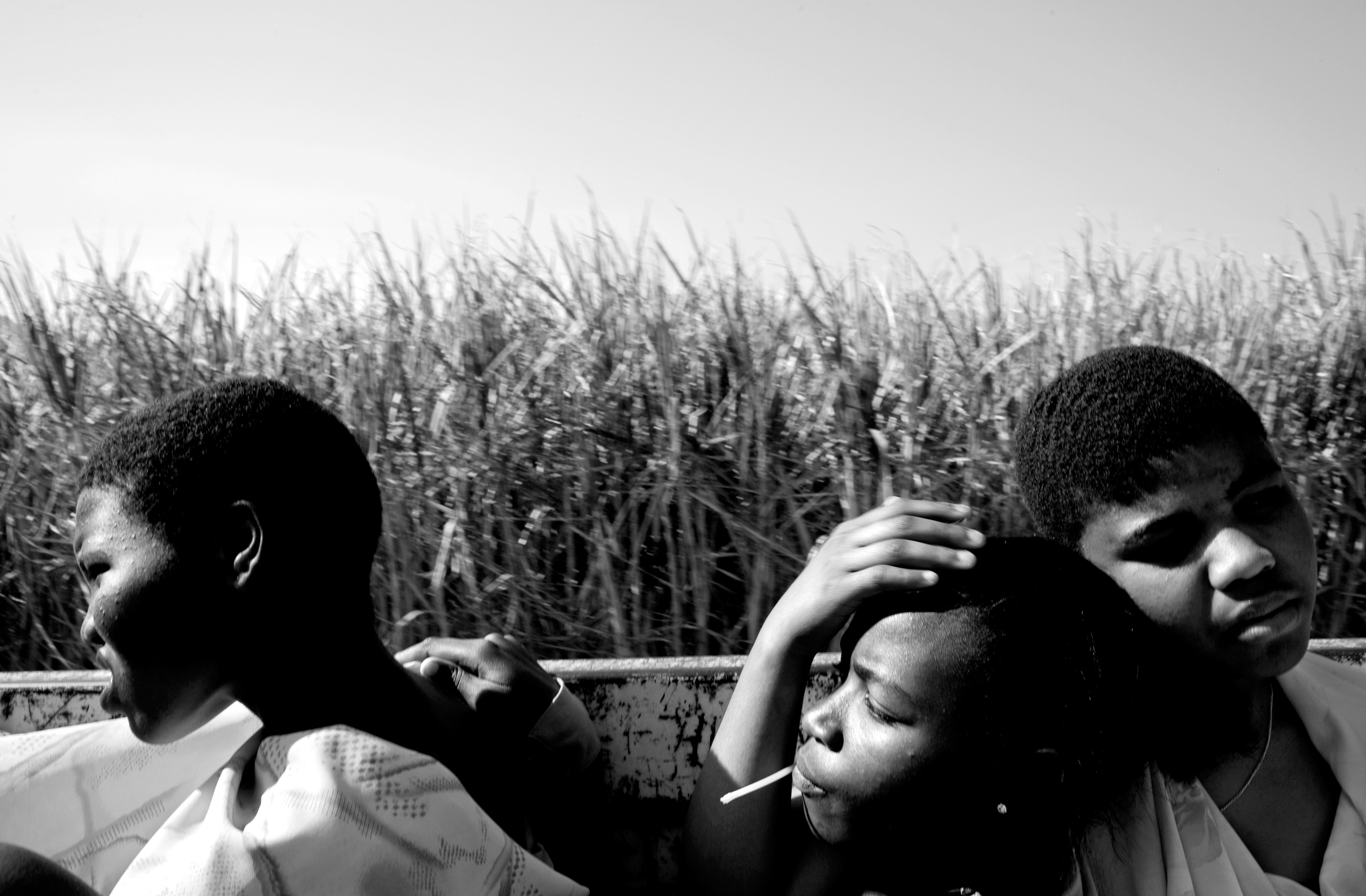 Swazi girls ride in the back of a truck through the sugar cane fields during the annual Umhlanga Dance, a right of passage into womanhood in Swaziland.