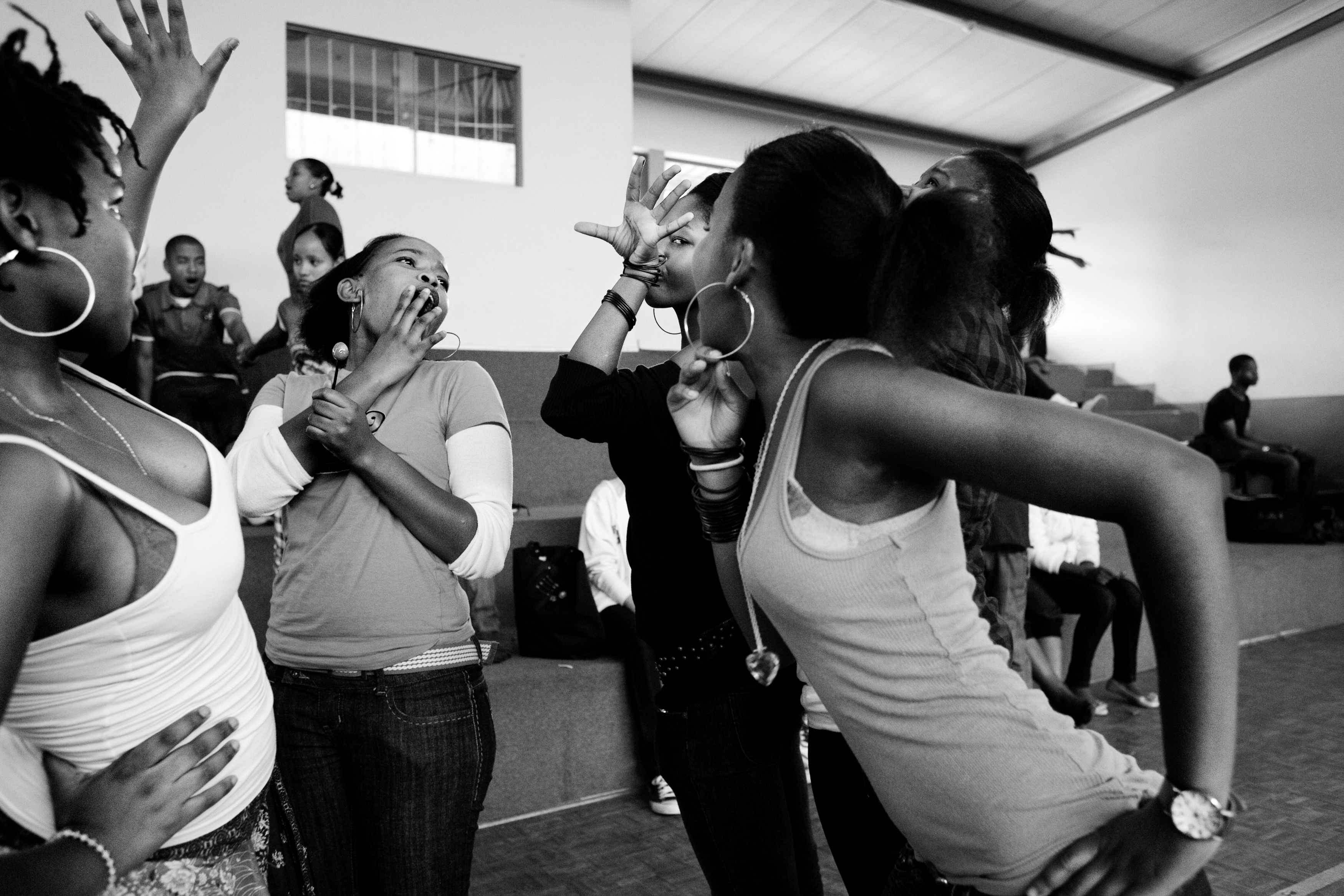 High school girls joke and dance to music during a hip hop dance competition held at a private high school in Swaziland. While some Swazis can afford private education, two thirds of Swazis live below the poverty line.