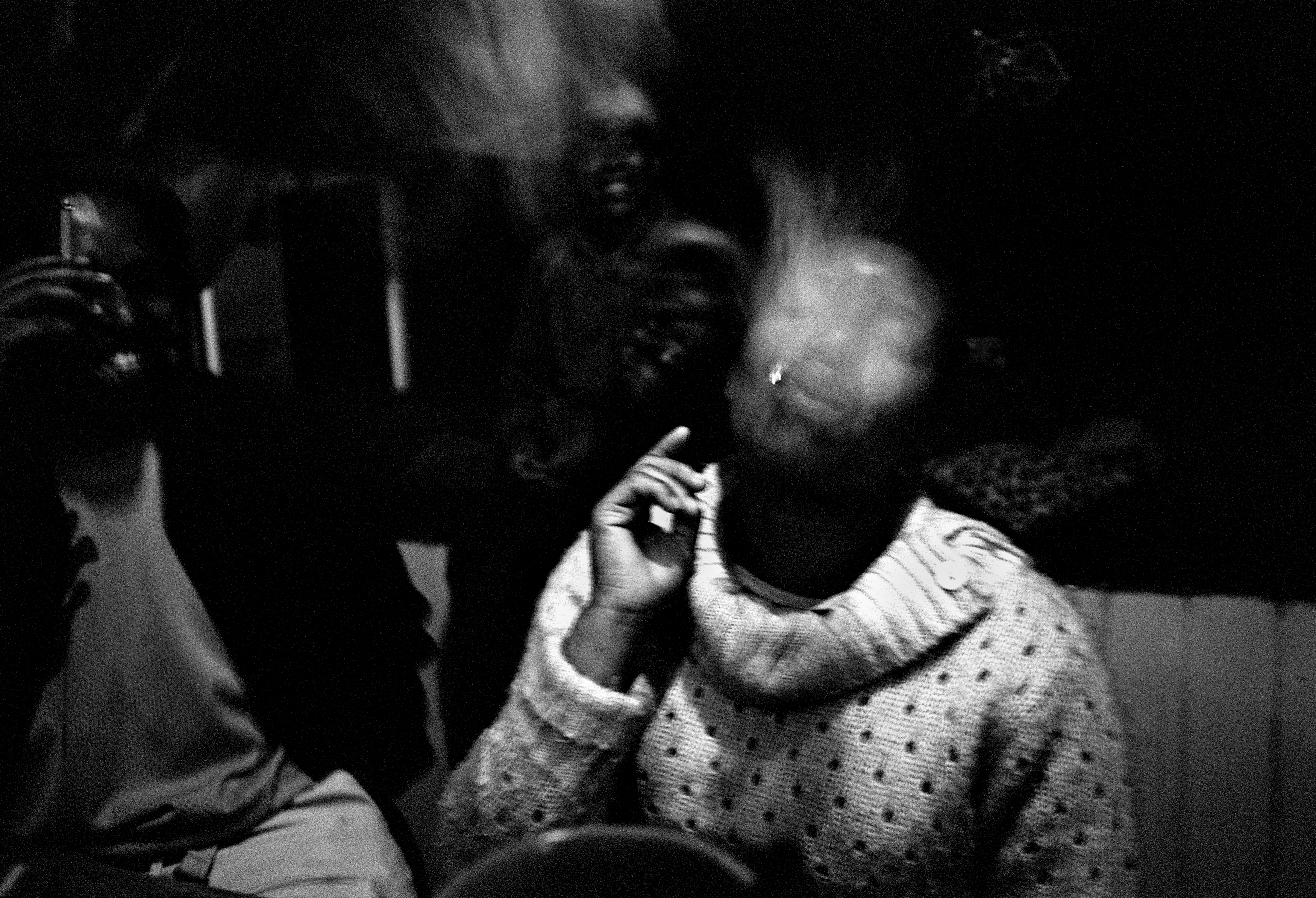 A young Swazi woman parties with men from Johannesburg at a rural bar.