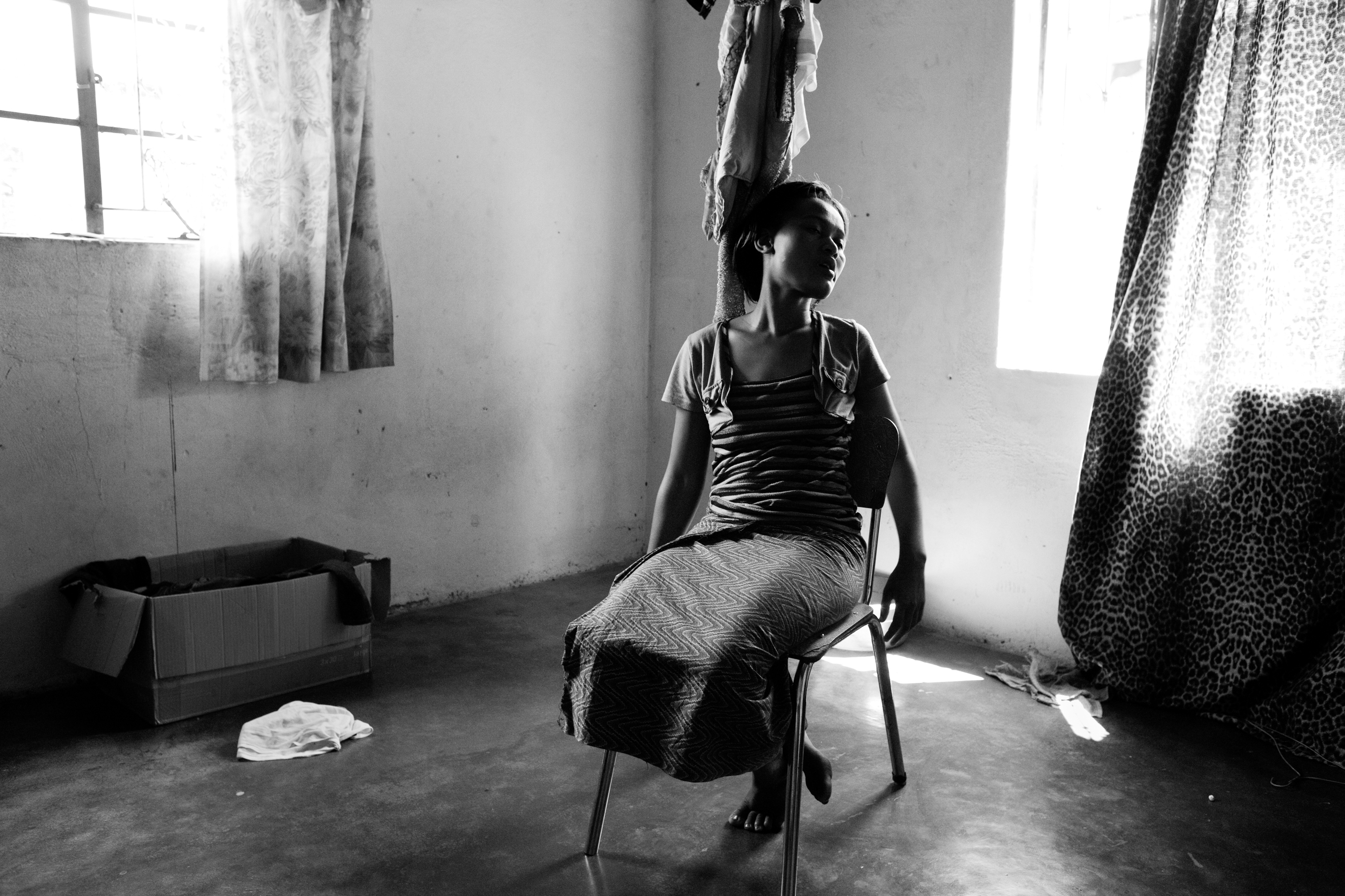 An HIV-positive woman, 20, grieves the loss of her one-year-old son due to AIDS. She is now often found alone, despondent and quiet. She refuses to begin ARV treatment due to stigma and fear.