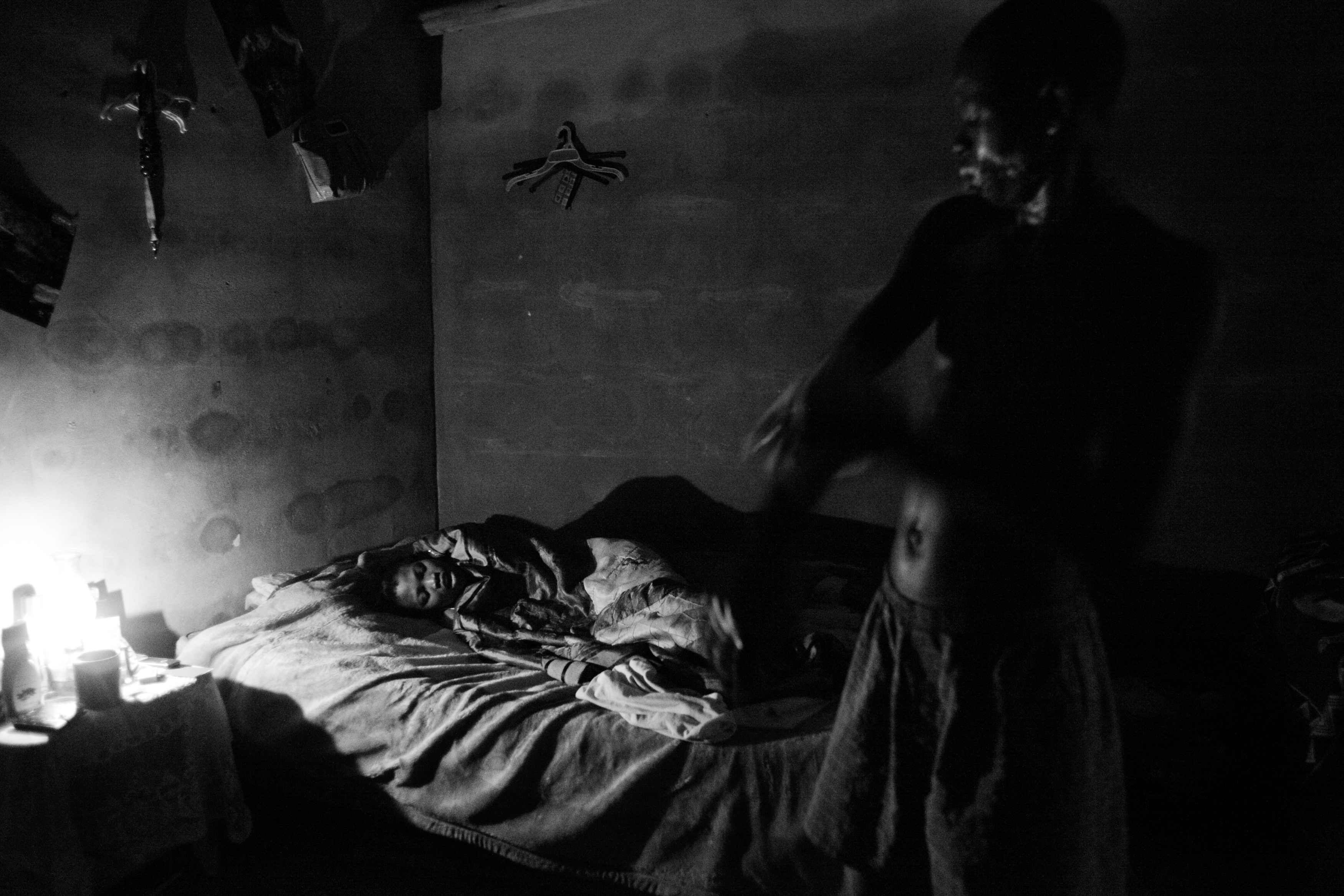 An HIV-positive couple wake and prepare for work in their one room rented flat near the industrial city of Matsapha. Both struggle to find consistent work in the factories.
