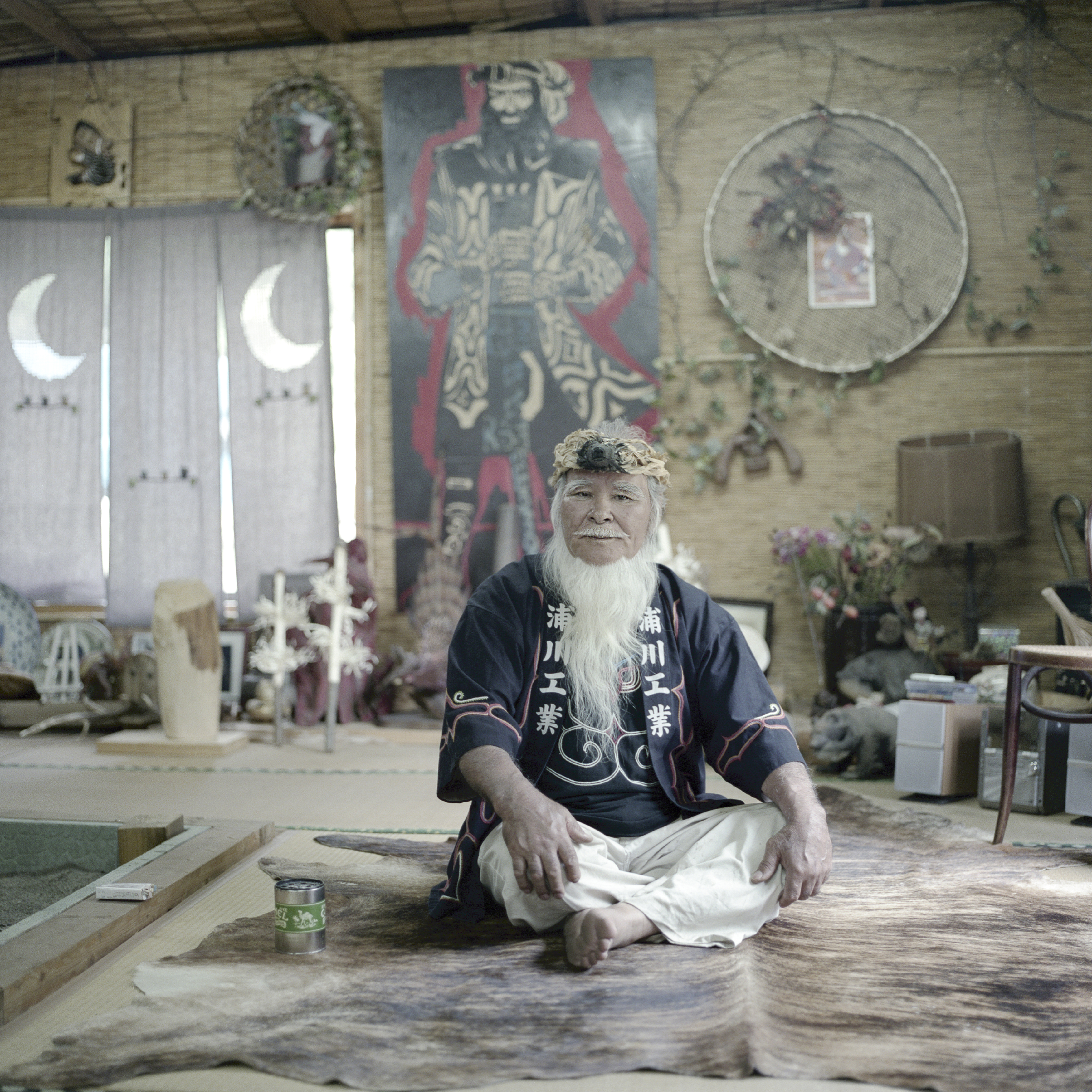 Kamuy Mintara, Chiba Prefecture, Greater Tokyo, Japan 2012
Ainu elder Haruzo Urakawa in his home. Kamuy Mintara, meaning `Playground of Gods`, is a Cise, a traditional Ainu home, that 75 [in 2012] years old Haruzo Urakawa built by himself in the mountains outside of Tokyo. Here, he lived as close as possible to the traditional Ainu lifestyle which, as a child in Hokkaido, he had learned from his father. [Today Kamuy Mintara has closed down].