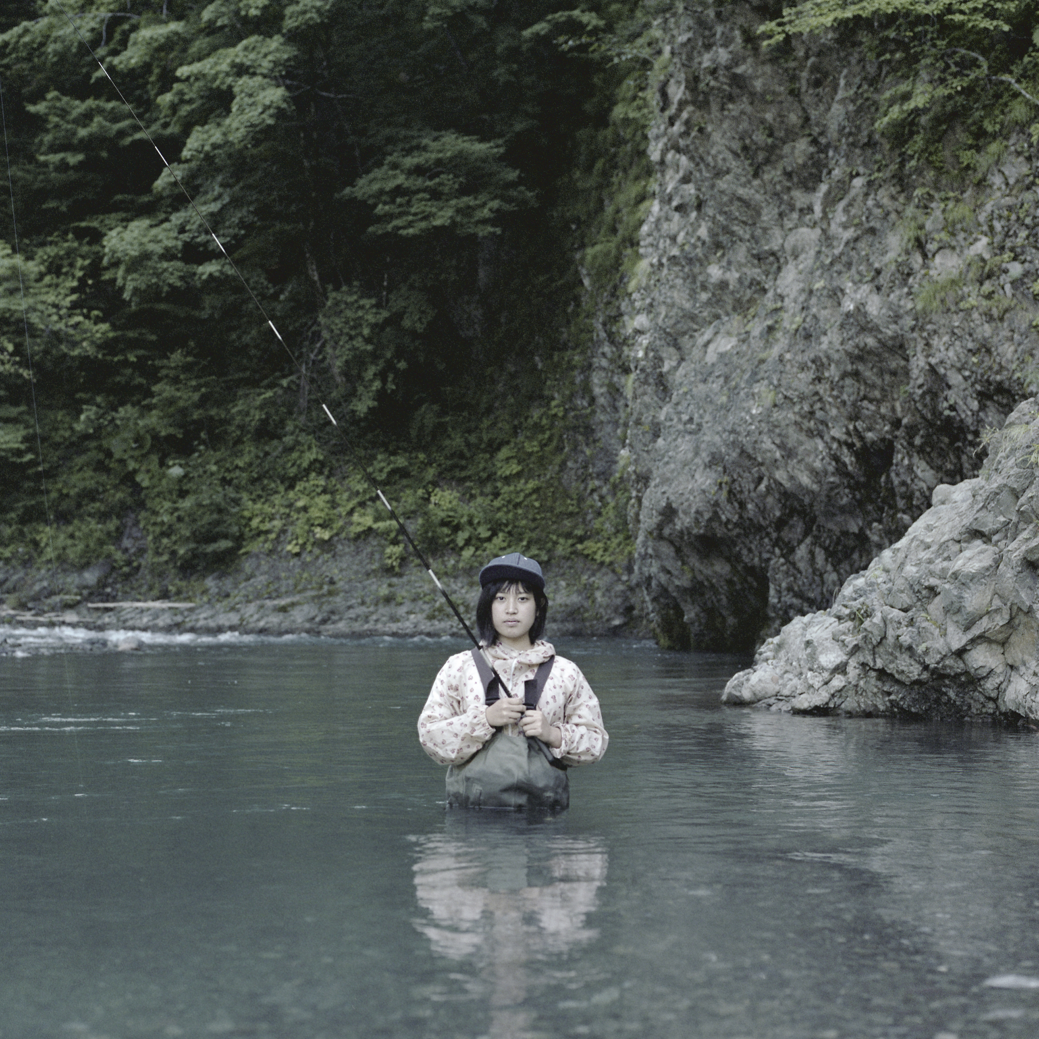 Biratori, Hokkaido, Japan 2016
Maya, a high school student, stands in her fishing gear in the river near her family home during summer vacation.